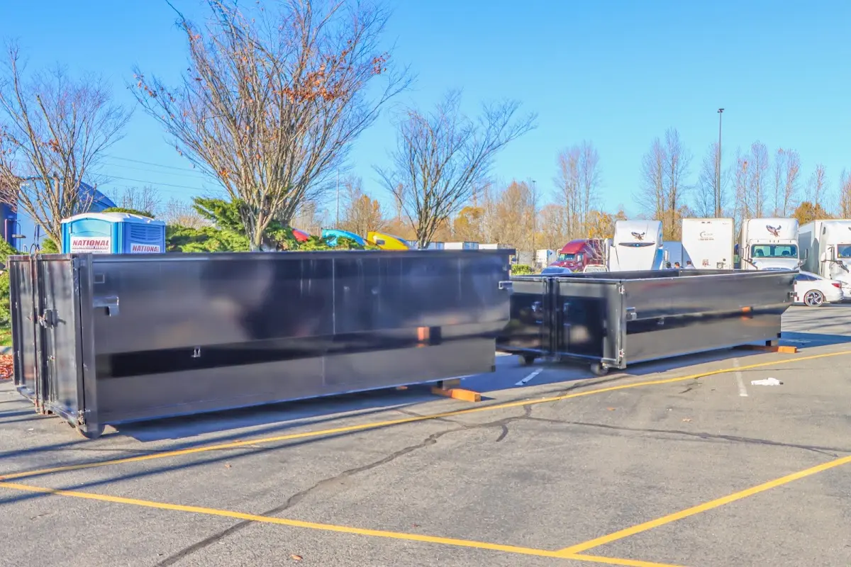 Professional dumpster rental service with roll-off container on residential driveway in Hamburg